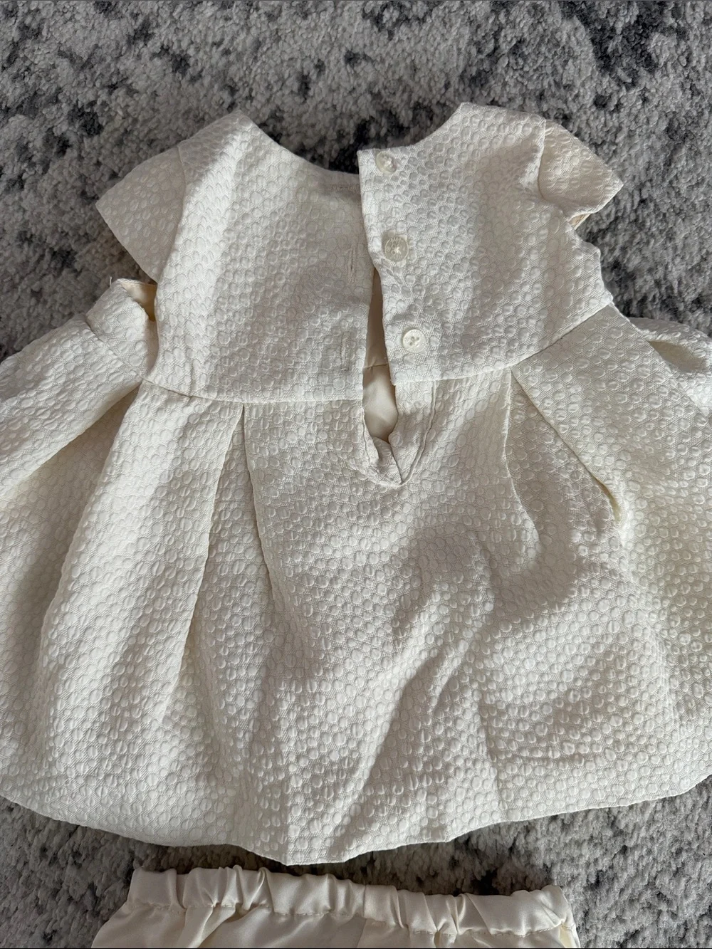 Pippa & Julie Ivory Textured Dress with Ruffle Front and Matching Bloomers